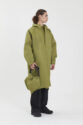 Green Rain coat on model. Off white background. Shot at SHED Packshot and Product Photography Studio